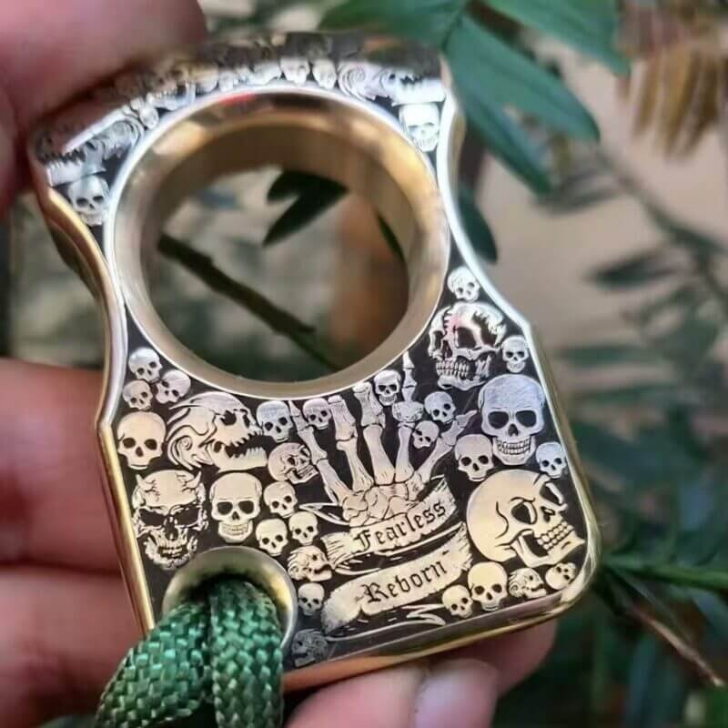 A close-up of finely carved brass knuckles self defense featuring a skull motif, designed for self-defense