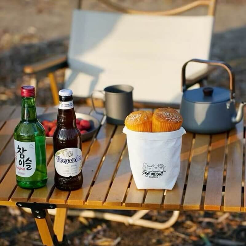 A White Water-proof Kraft Paper Storage Organizer holding Bread on a Camping Table