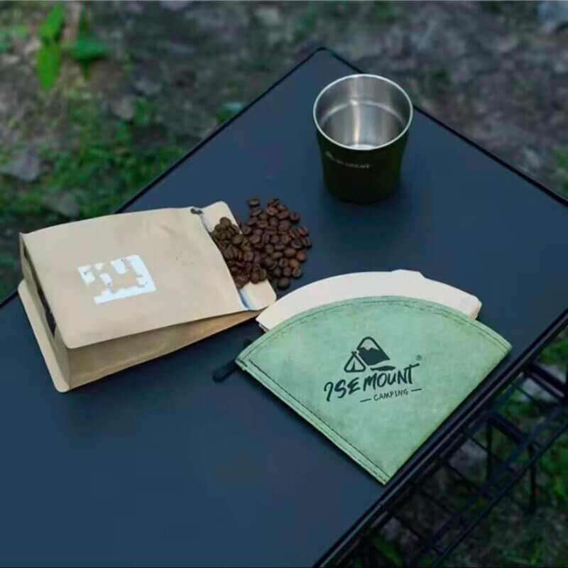 A coffee filter holder placed on a camping table